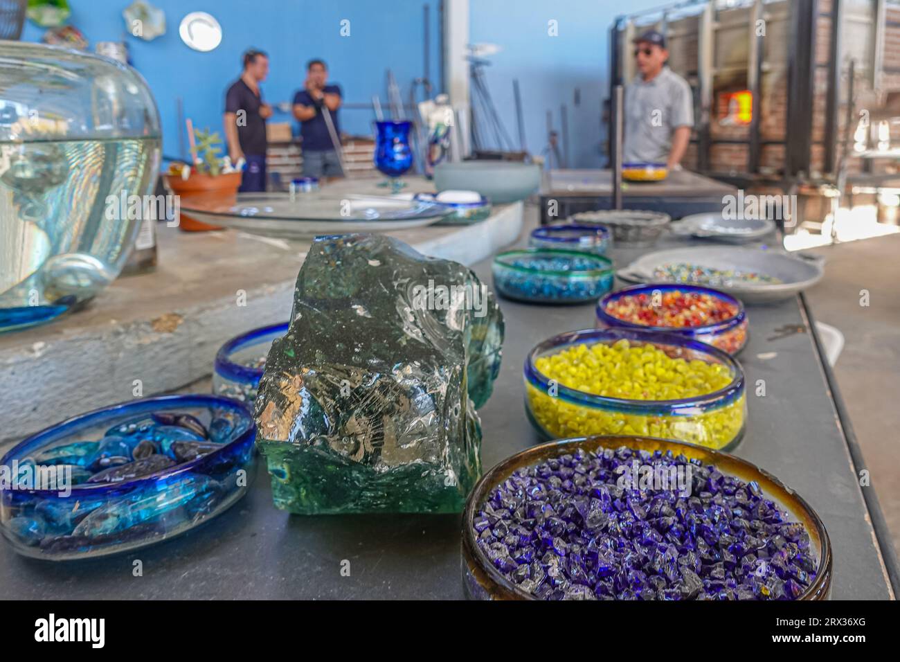 Mexico, Cabo San Lucas - July 16, 2023: La Fabrica de Vidrio Soplado. Hand blown artistic glass factory. Dishes filled with different color pellets cl Stock Photo