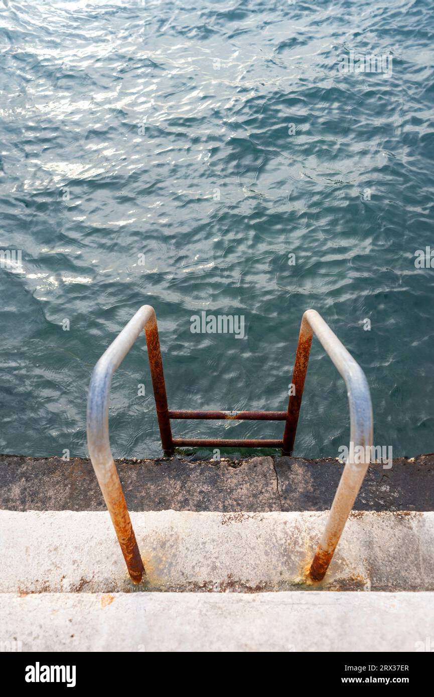 Metal ladder into the sea for swimming Stock Photo