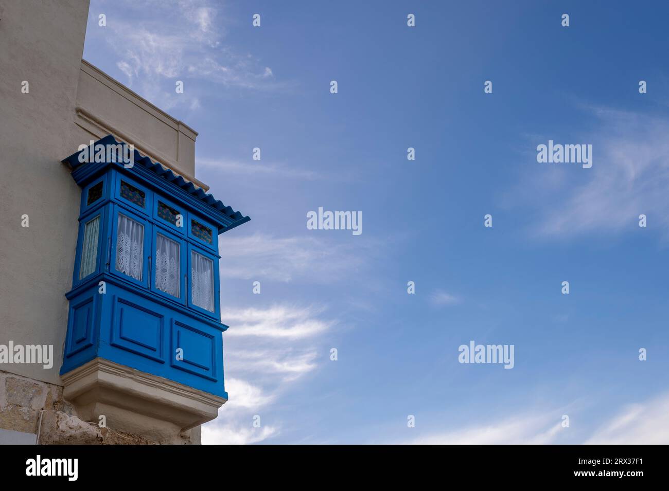 Traditional Maltese covered balcony in Valetta, painted blue. Stock Photo