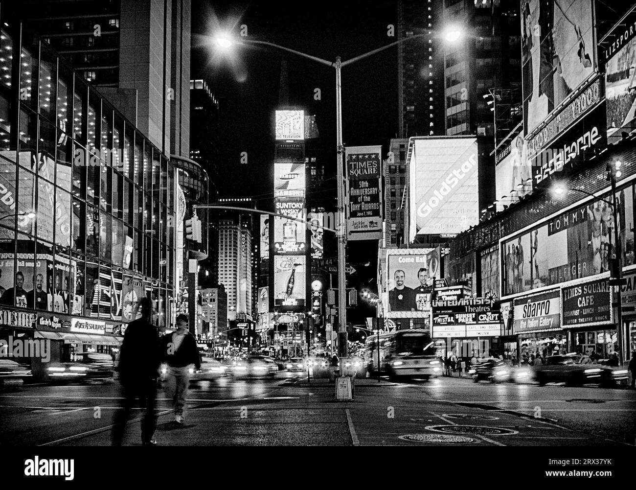 The nocturnal but brightly lit Times Square at the intersection of Broadway and Seventh Avenue in New York City was named after the newspaper based th Stock Photo