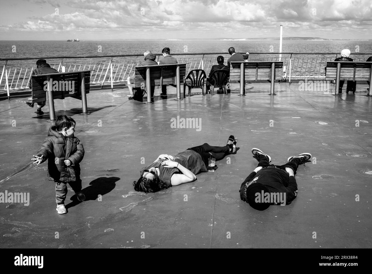 Tired passengers on the ship deck Black and White Stock Photos & Images ...