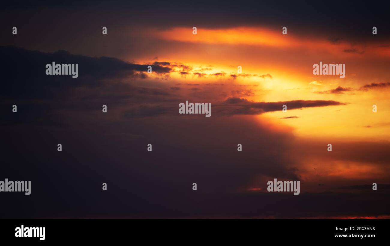 Picturesque view of orange sky with dark clouds in sunset time Stock ...