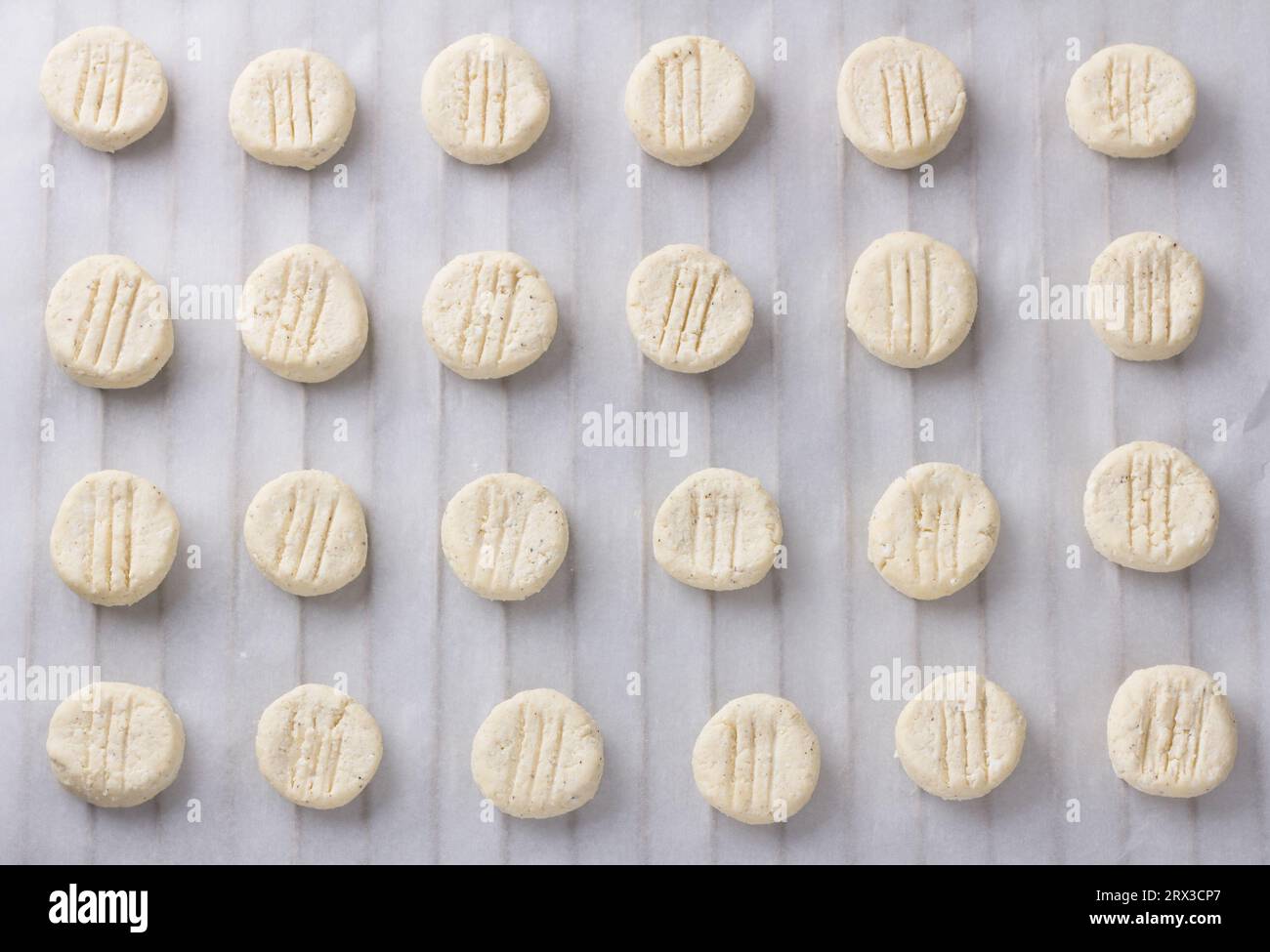 Raw cottage cheese gnocchi on white parchment, top view. Cooking stage Stock Photo