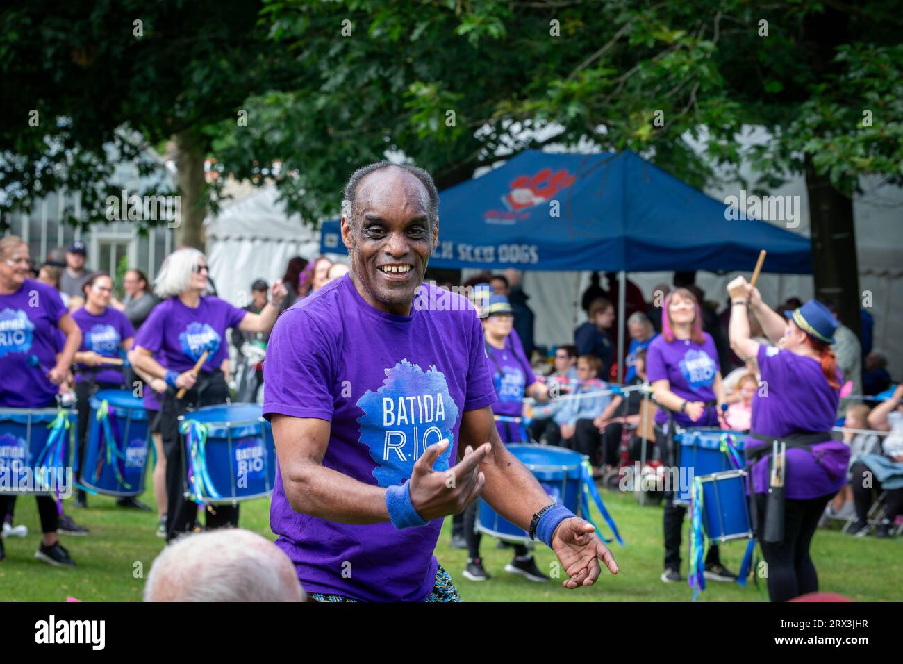 Black man dances to the rhythm of the Batida Rio Samba drumming group