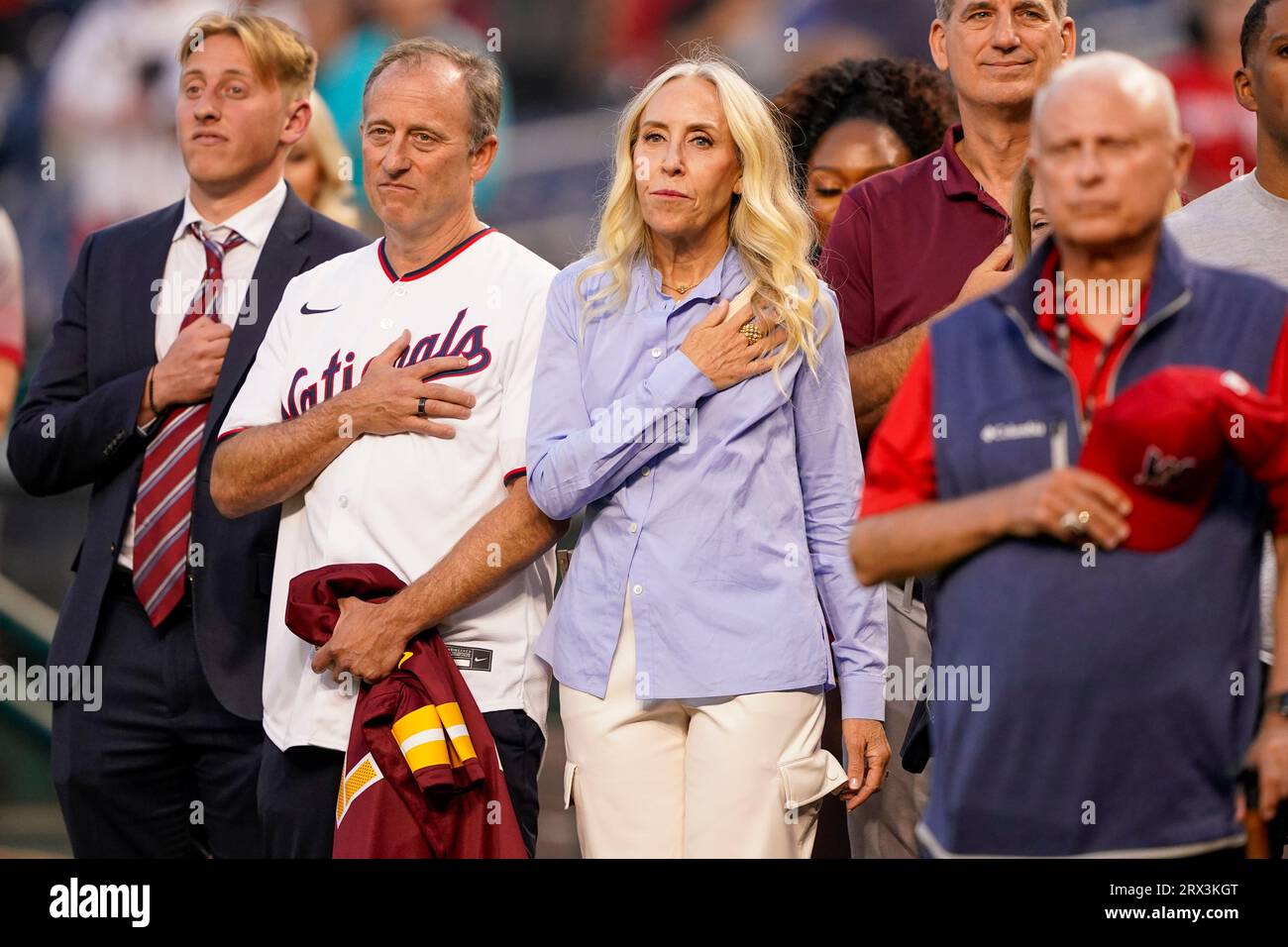 From left, Washington Nationals principal owner Mark Lerner, speaks with  Washington Commanders team owner Josh Harris and his son Stuart and wife  Marjorie before Harris throws out the ceremonial first pitch before