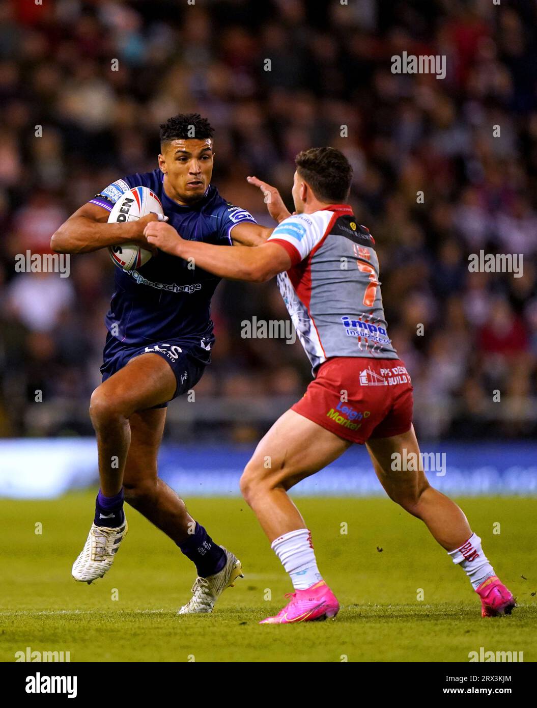 Wigan Warriors' Kai Pearce-Paul (left) is tackled by Leigh Leopards' Lachlan Lam during the Betfred Super League match at Leigh Sports Village. Picture date: Friday September 22, 2023. Stock Photo