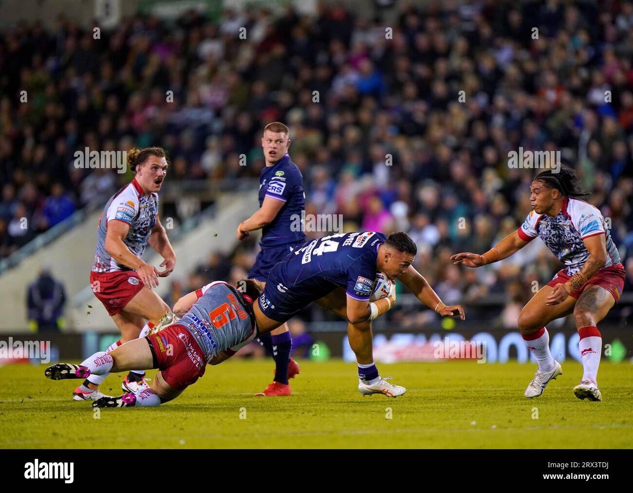 Wigan Warriors' Tyler Dupree is tackled by Leigh Leopards' Joe Mellor