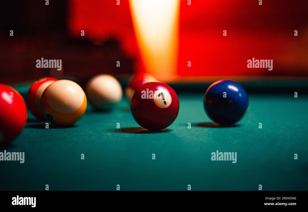 Detailed photo of pool (billiard) balls on cozy warm backround with orange lighting. Close up image of colorful billiard balls. Stock Photo
