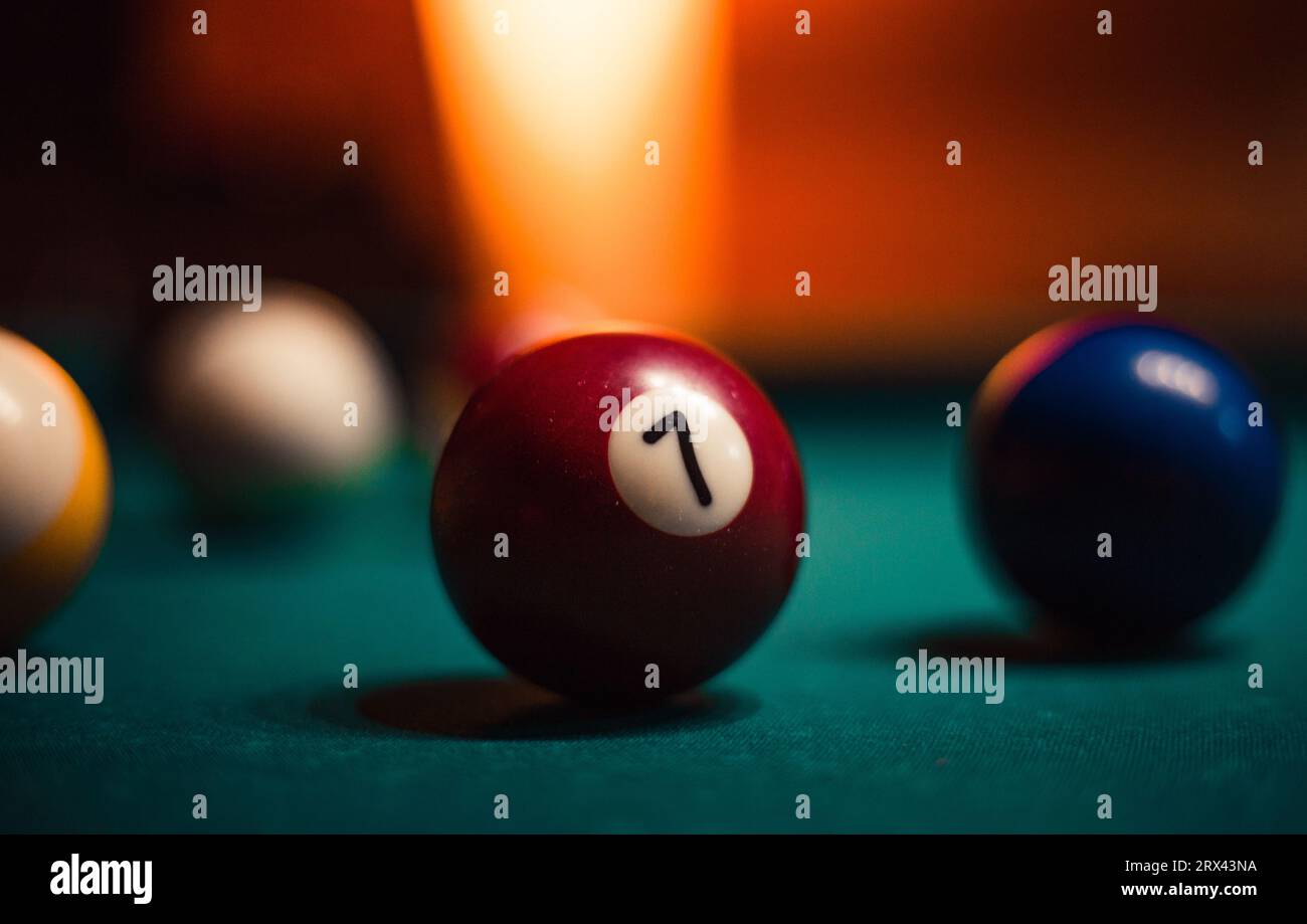 Detailed photo of pool (billiard) balls on cozy warm backround with orange lighting. Close up image of colorful billiard balls. Stock Photo