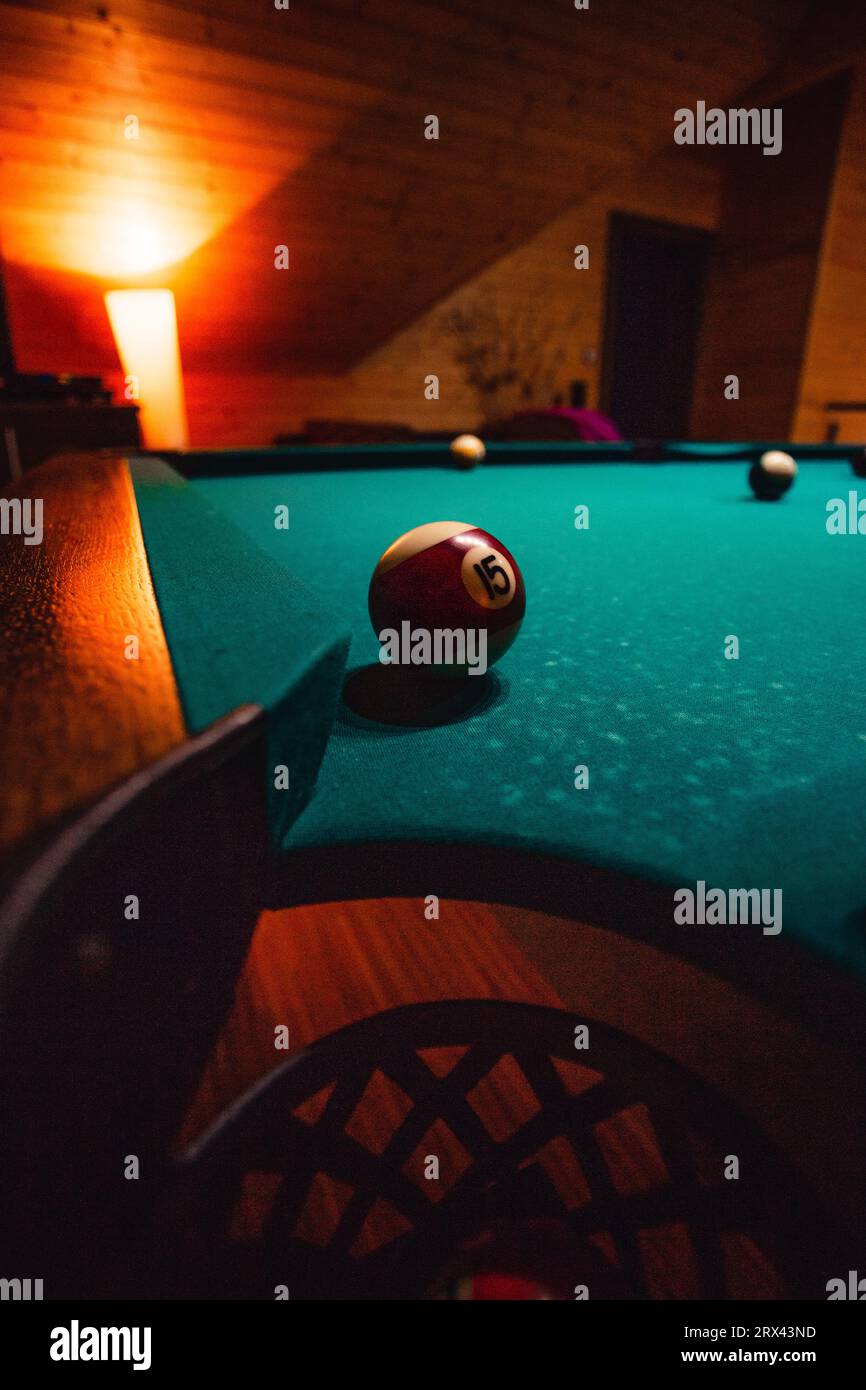 Vertical detailed photo of pool (billiard) balls on cozy warm backround with orange lighting. Close up image of colorful billiard balls. Stock Photo