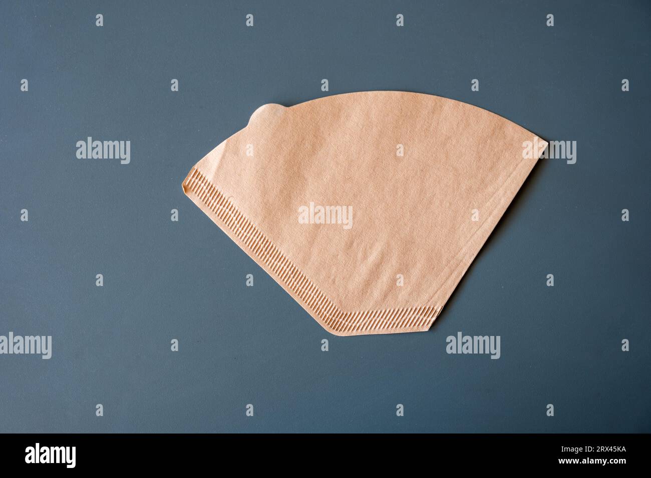 Coffee filter used for american coffee machine on green background with