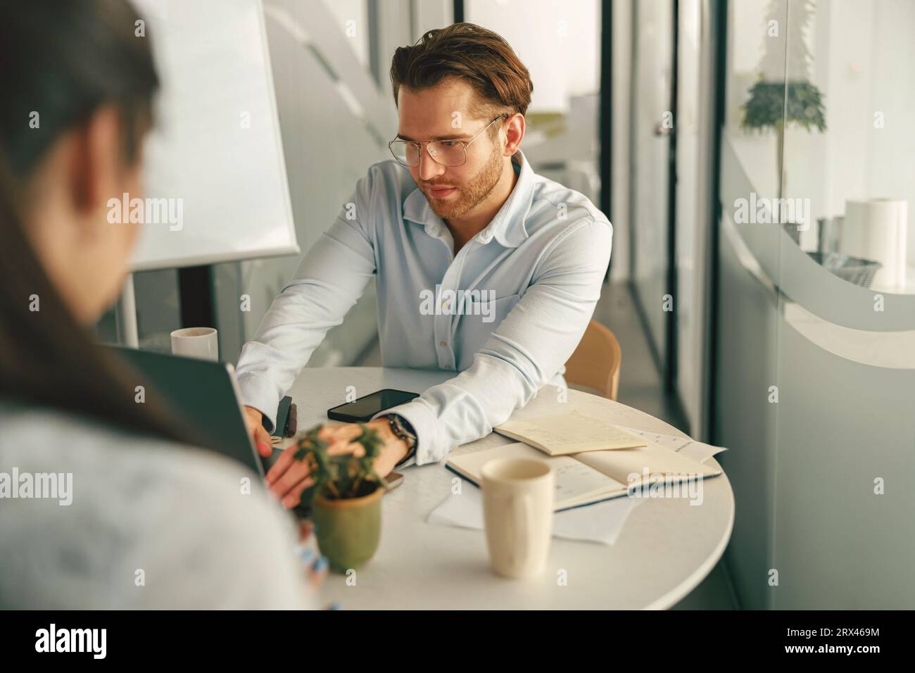 Two diverse business people working in modern coworking space Stock ...