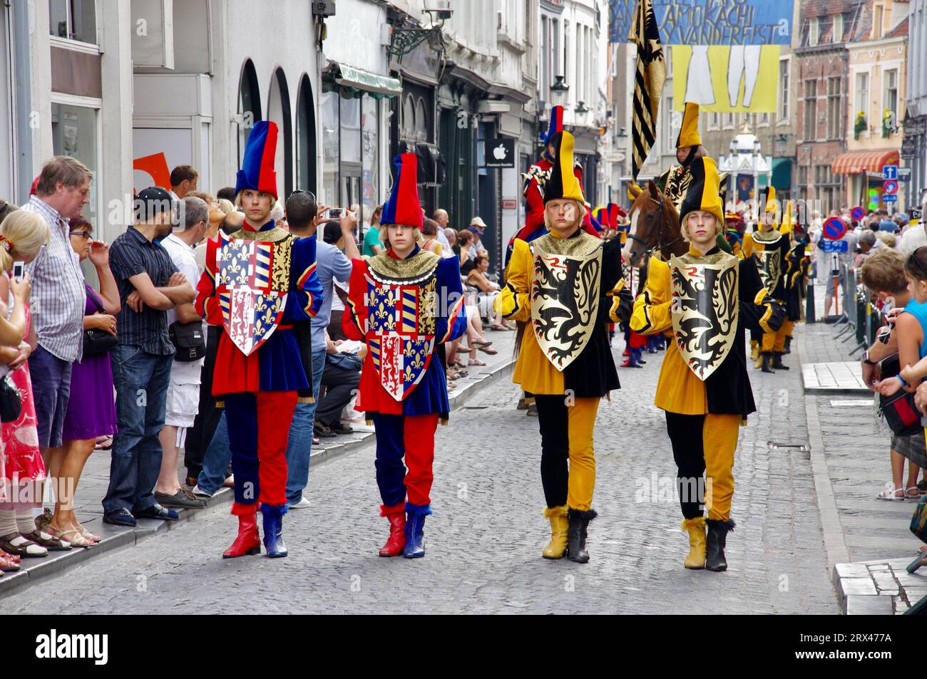 Marchers in colourful outfits in The 2012 Procession of the Golden Tree Pageant, held every 5 years since 1958. Bruges, Belgium. Stock Photo