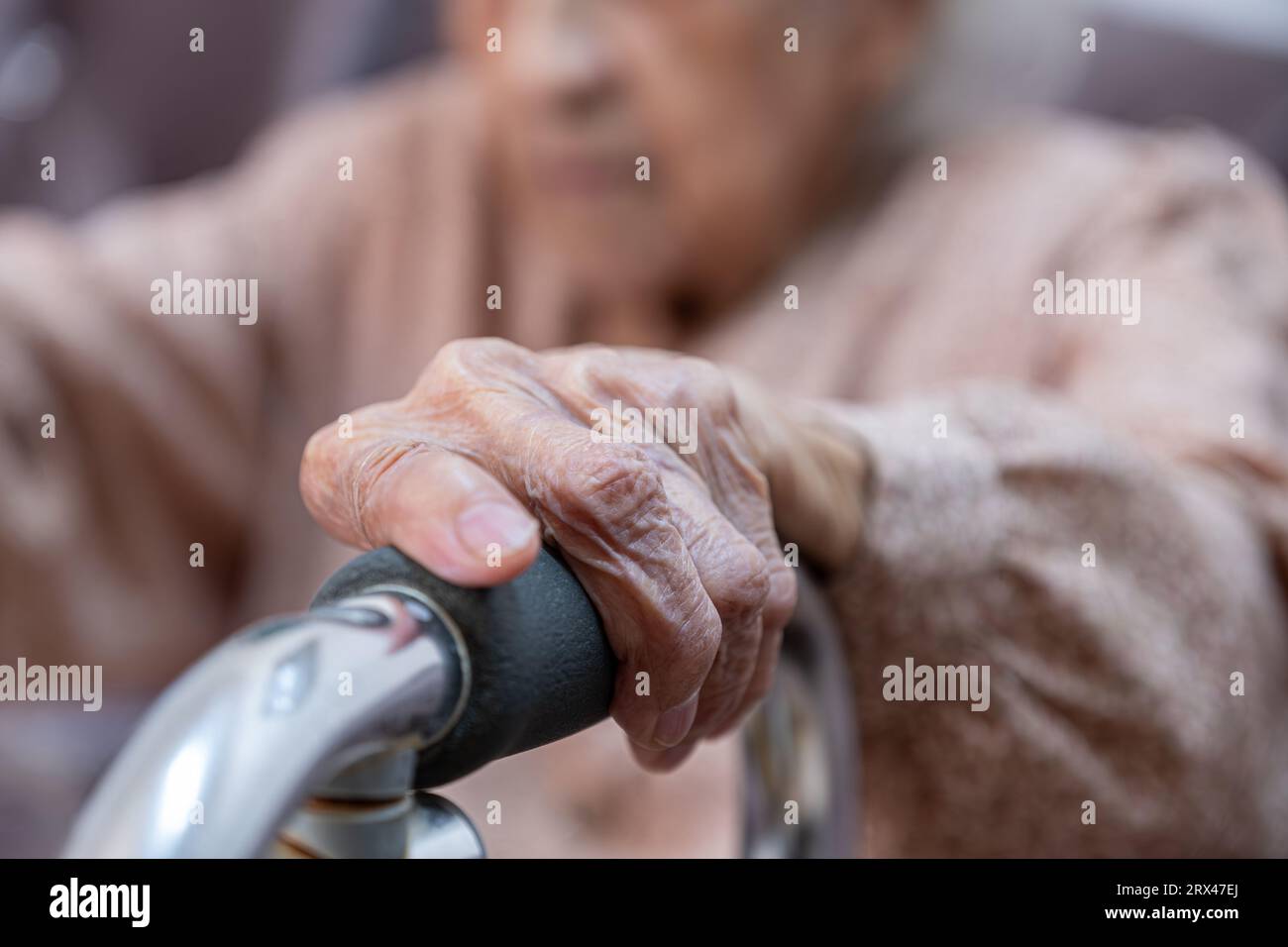 old woman using walker due to disability and illness in her knee Stock Photo