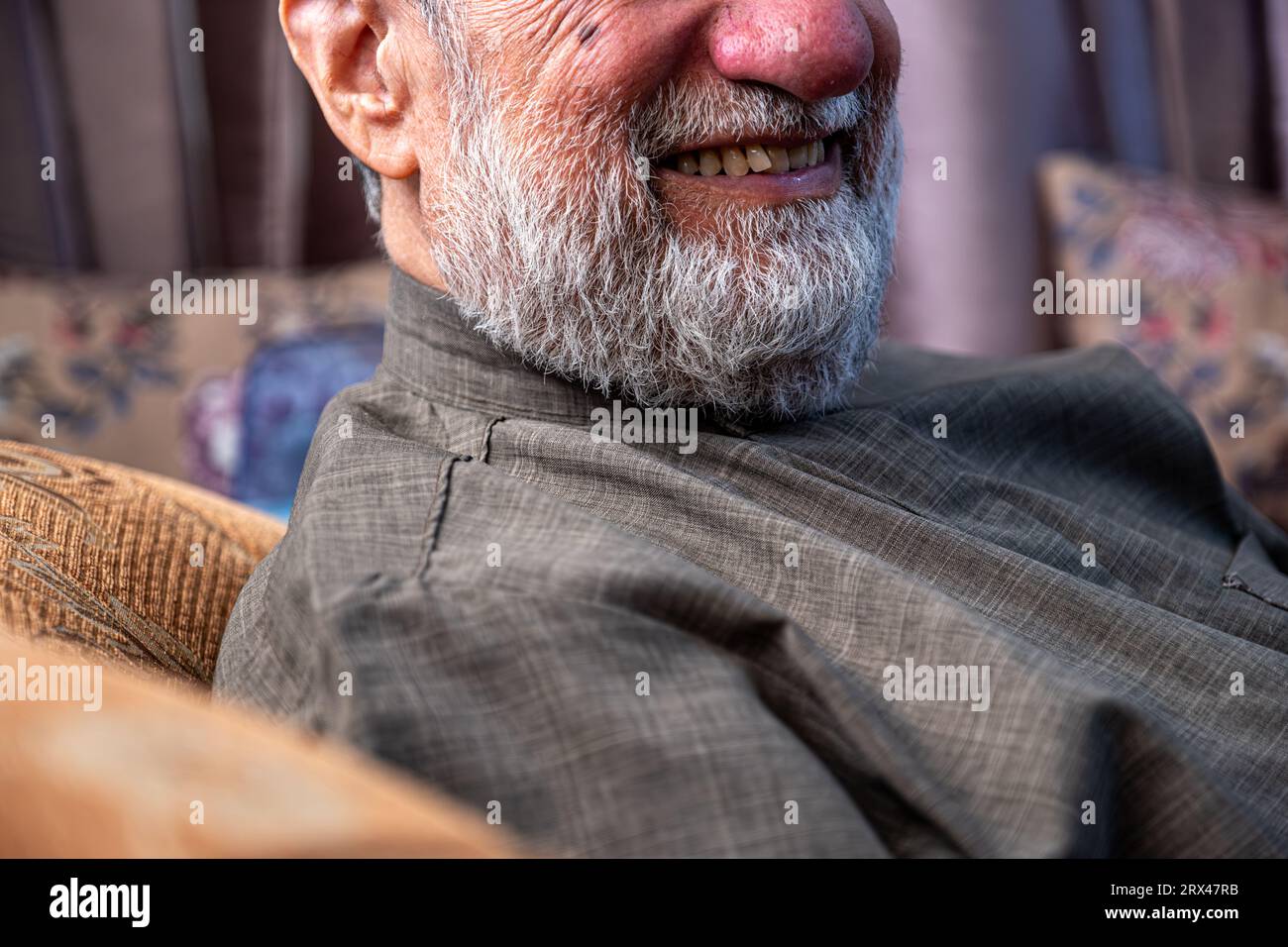 old man face smiling with bearded face in grey color Stock Photo