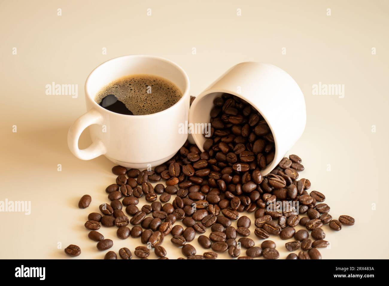 Coffee cups on off white background  full of coffee beans and coffee drink Stock Photo