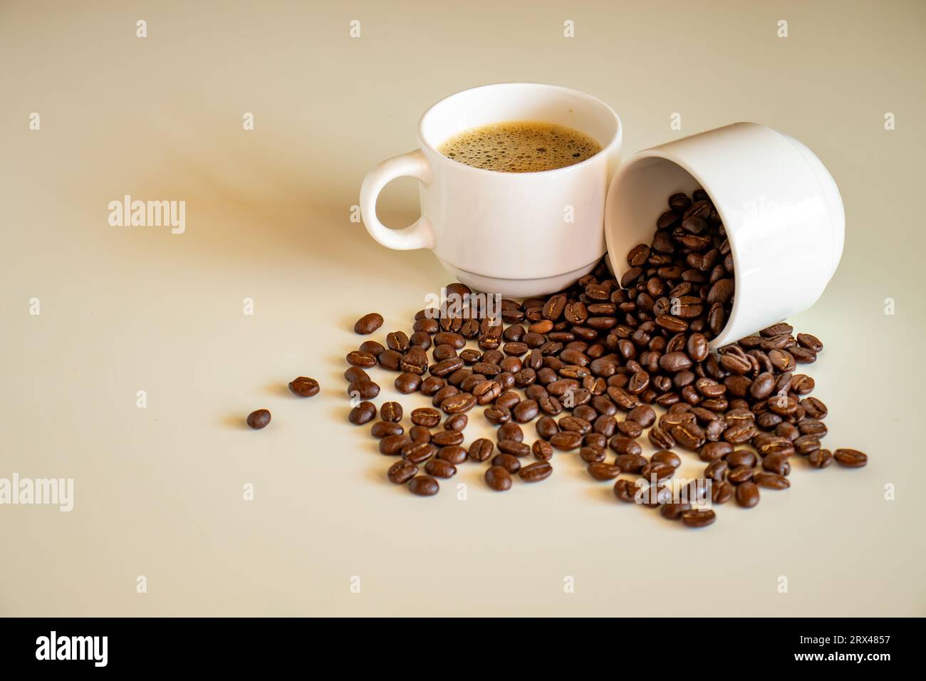Coffee cups on off white background  full of coffee beans and coffee drink Stock Photo