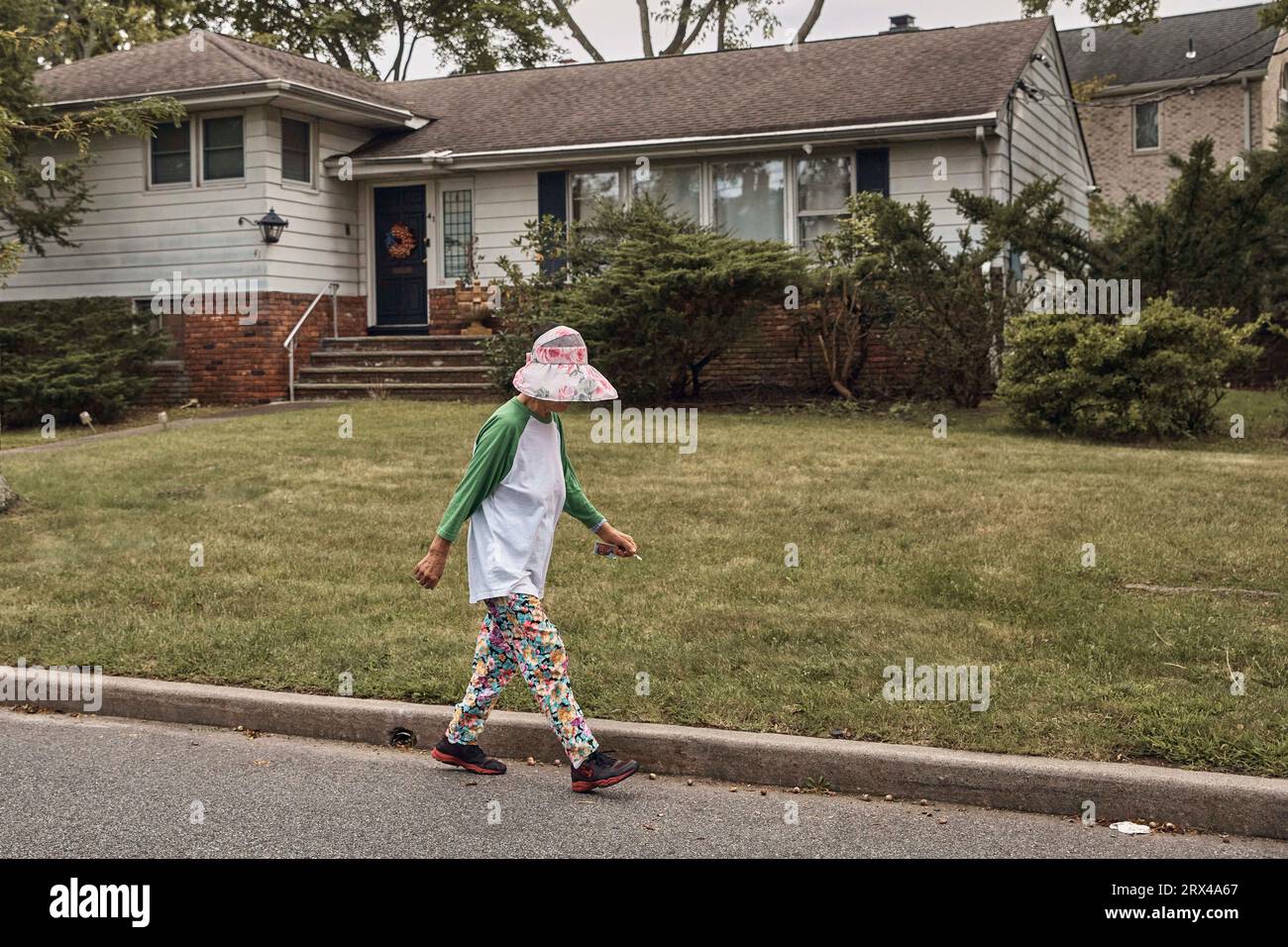 A woman walks by Sen. Bob Menendez' house, Friday, Sept. 22, 2023, in