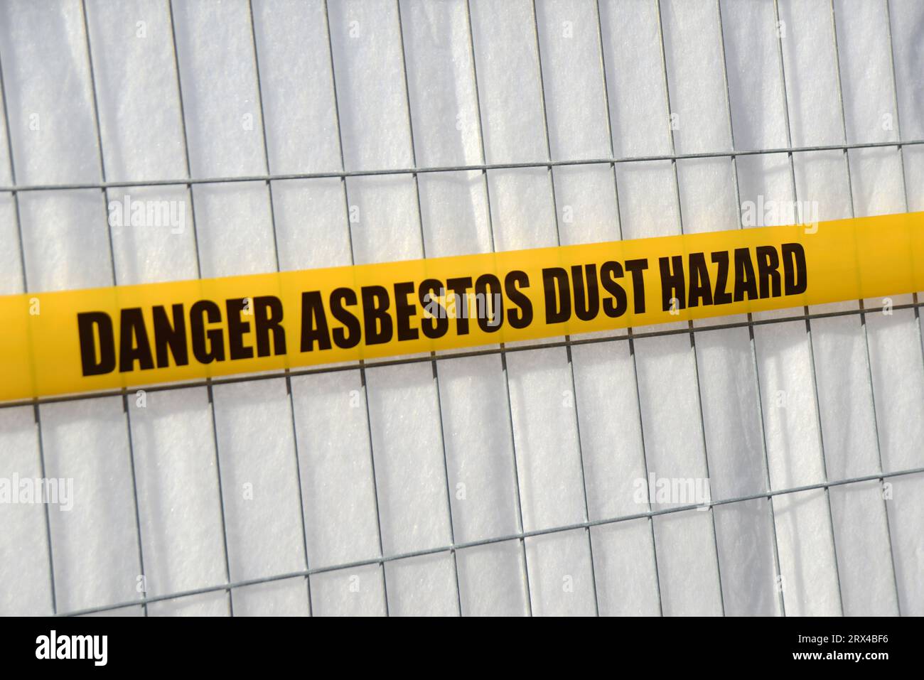 asbestos danger tape set up around a construction site Stock Photo Alamy