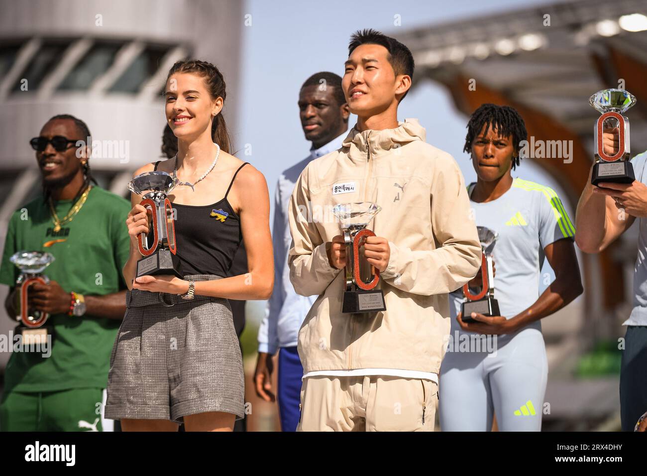 Yaroslava Mahuchikh (UKR) and Sanghyeok Woo (KOR) stand on the podium at the trophy ceremony at the Diamond League Championships at The Pre-Classic on Stock Photo