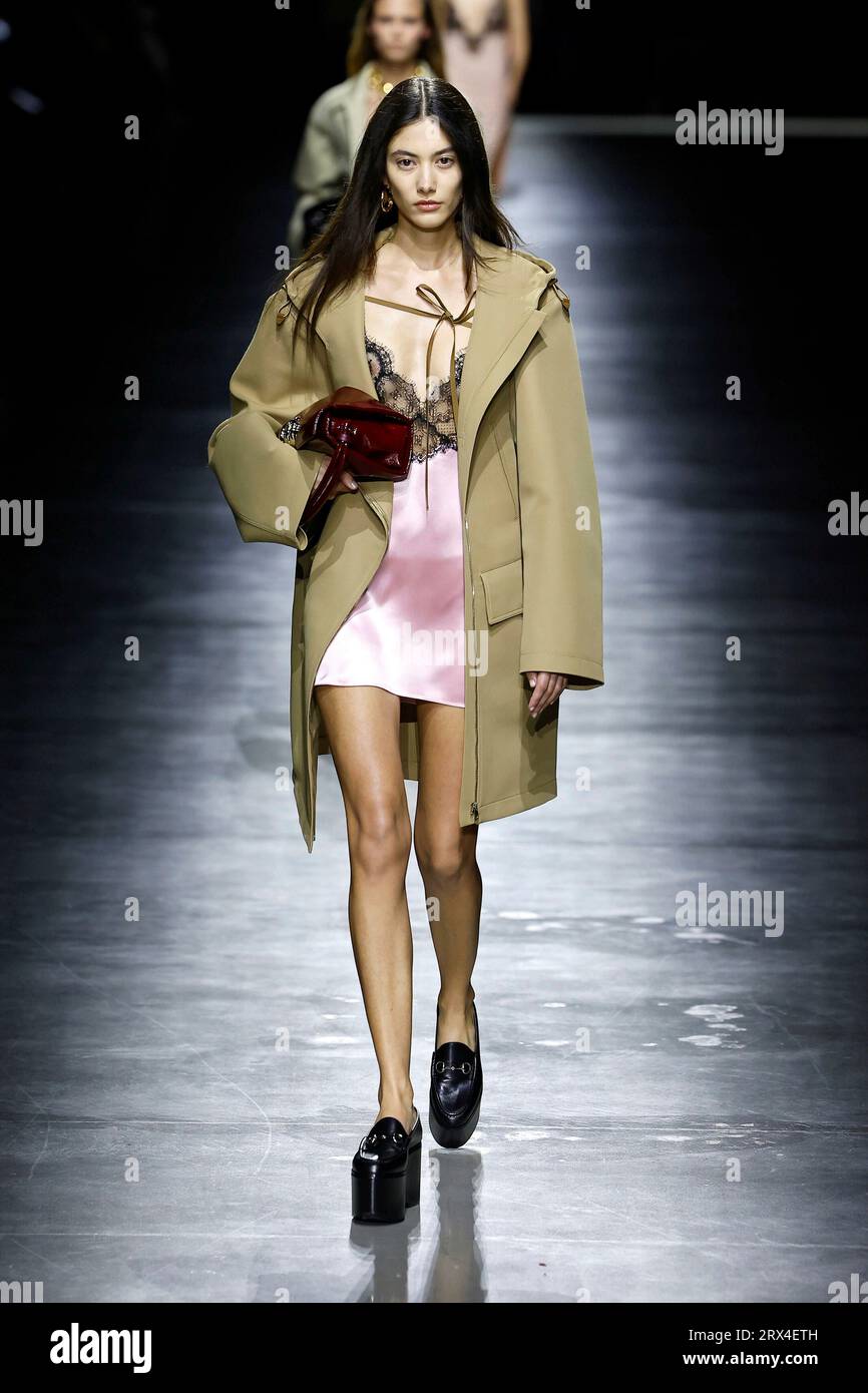 Woman with orange jacket and Balenciaga bag and man with Gucci bag before  John Richmond fashion show, Milan Fashion Week street style – Stock  Editorial Photo © AndreaA. #272373476