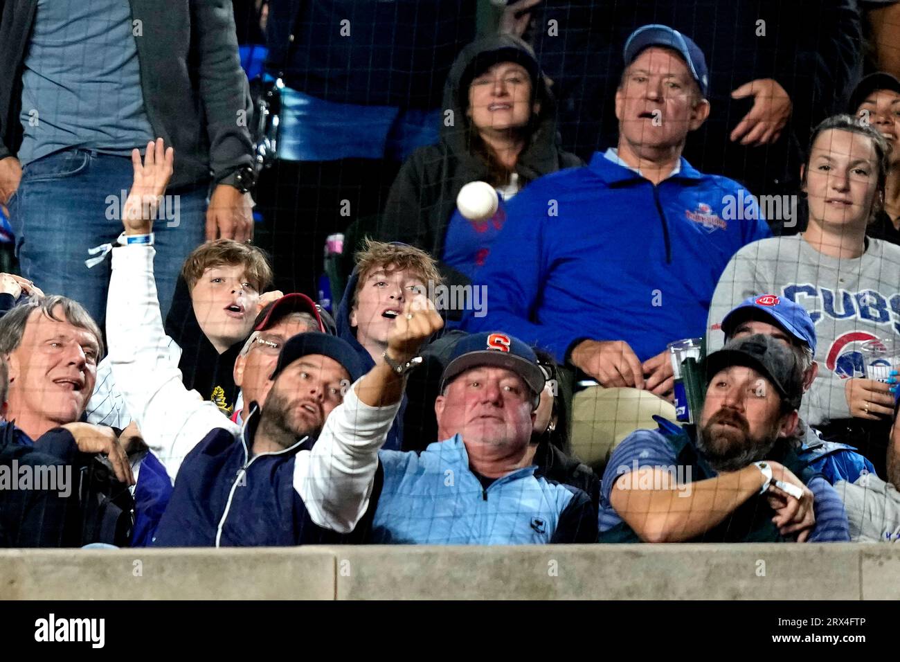 Chicago Cubs' Patrick Wisdom laughs as he reacts to fans during a