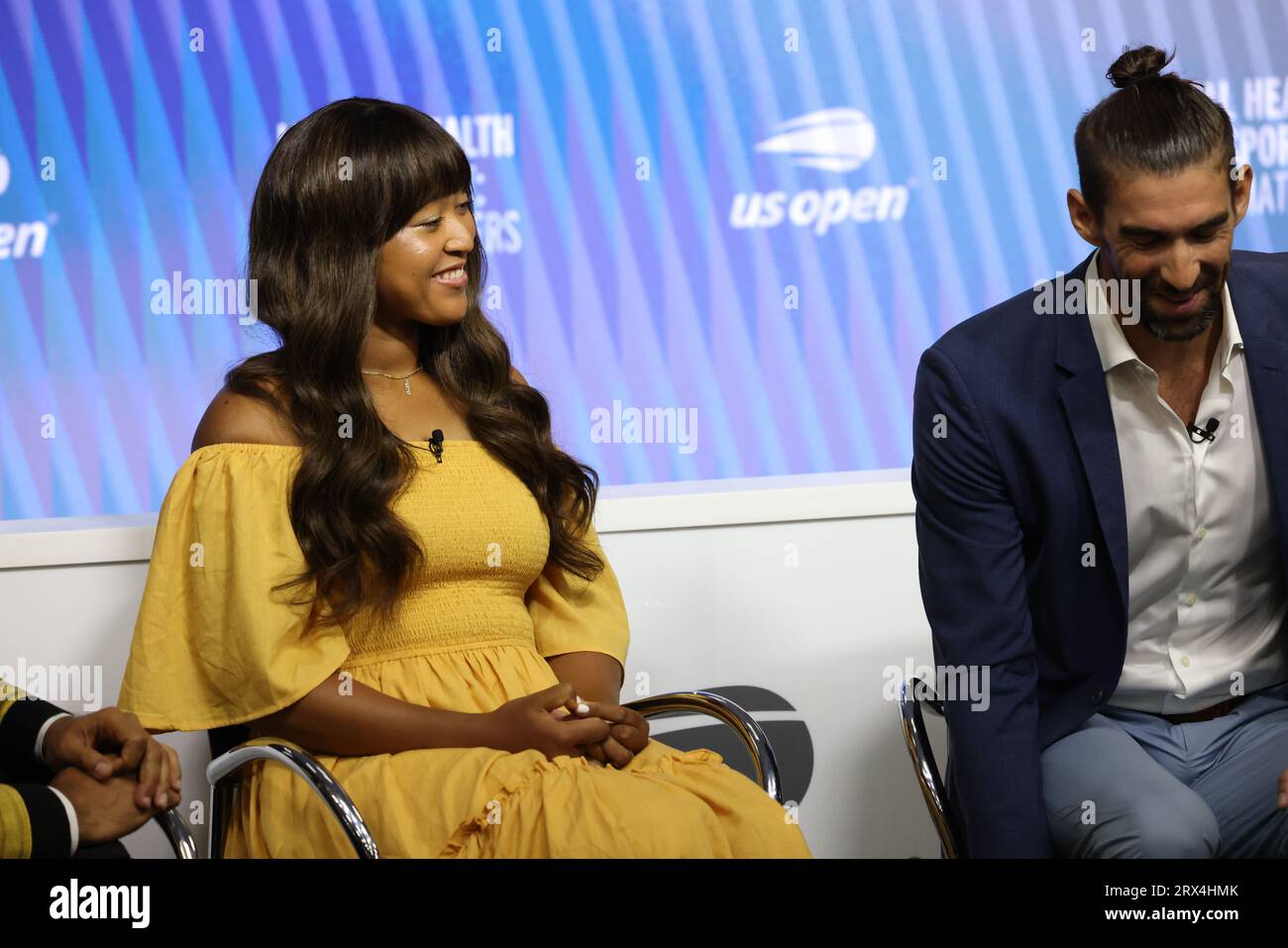 Tennis player Naomi Osaka and Olympic swimmer Michael Phelps share a laugh during Mental Health and Sport Press conference at US Open on 6 September 2023.  From Left to Right:  Also in attendance were US Surgeon General  Dr. Vivek H. Murthy, and USTA President Dr. Brian Hainline Stock Photo