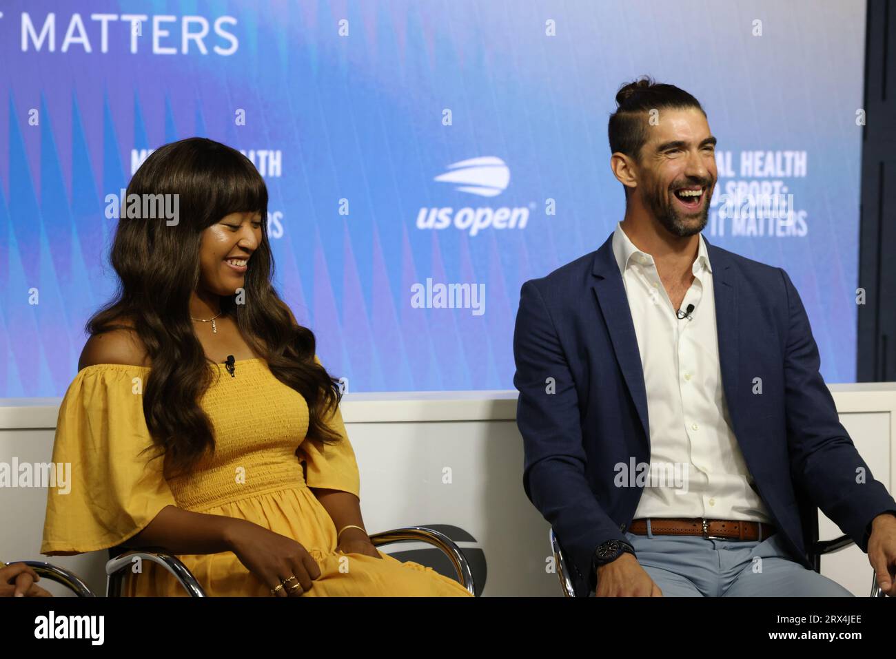 Tennis player Naomi Osaka and Olympic swimmer Michael Phelps share a laugh during Mental Health and Sport Press conference at US Open on 6 September 2023.  From Left to Right:  Also in attendance were US Surgeon General  Dr. Vivek H. Murthy, and USTA President Dr. Brian Hainline Stock Photo