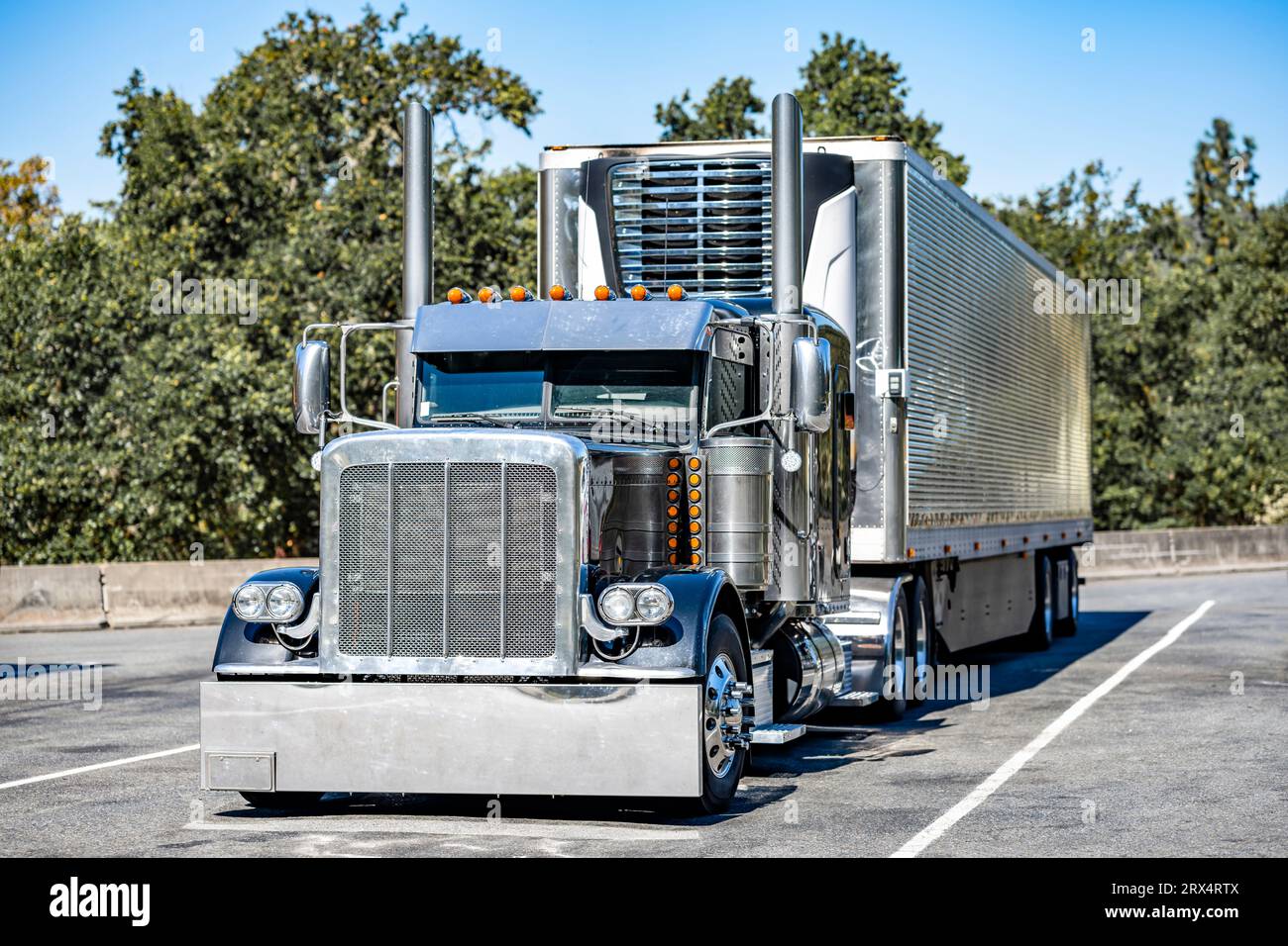 Industrial long hauler classic carrier black big rig semi truck tractor with extended cab for truck driver rest  transporting cargo in refrigerator se Stock Photo