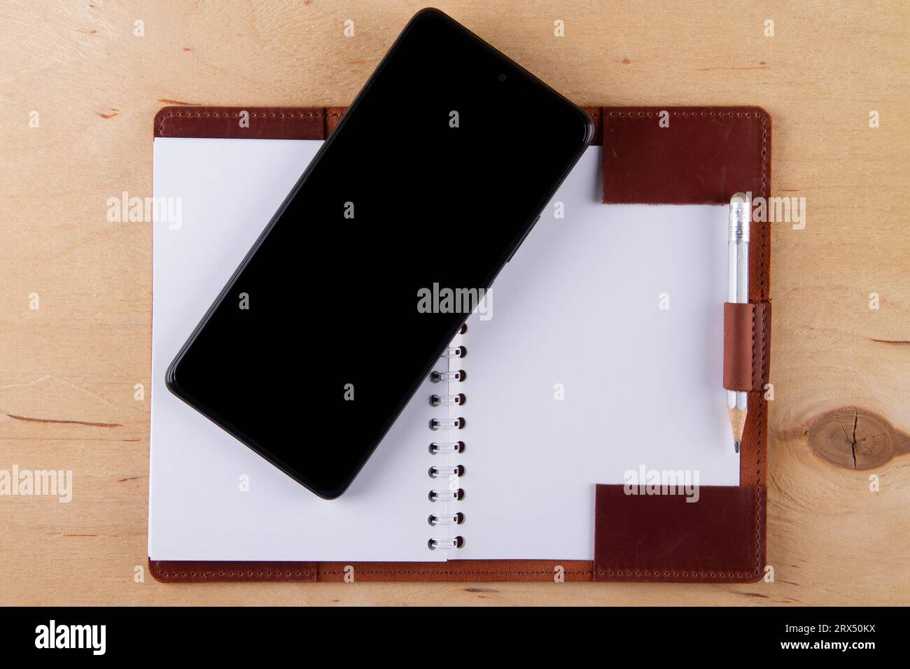 Digitalization concept. Paper notebook vs smartphone. Digital phone ...