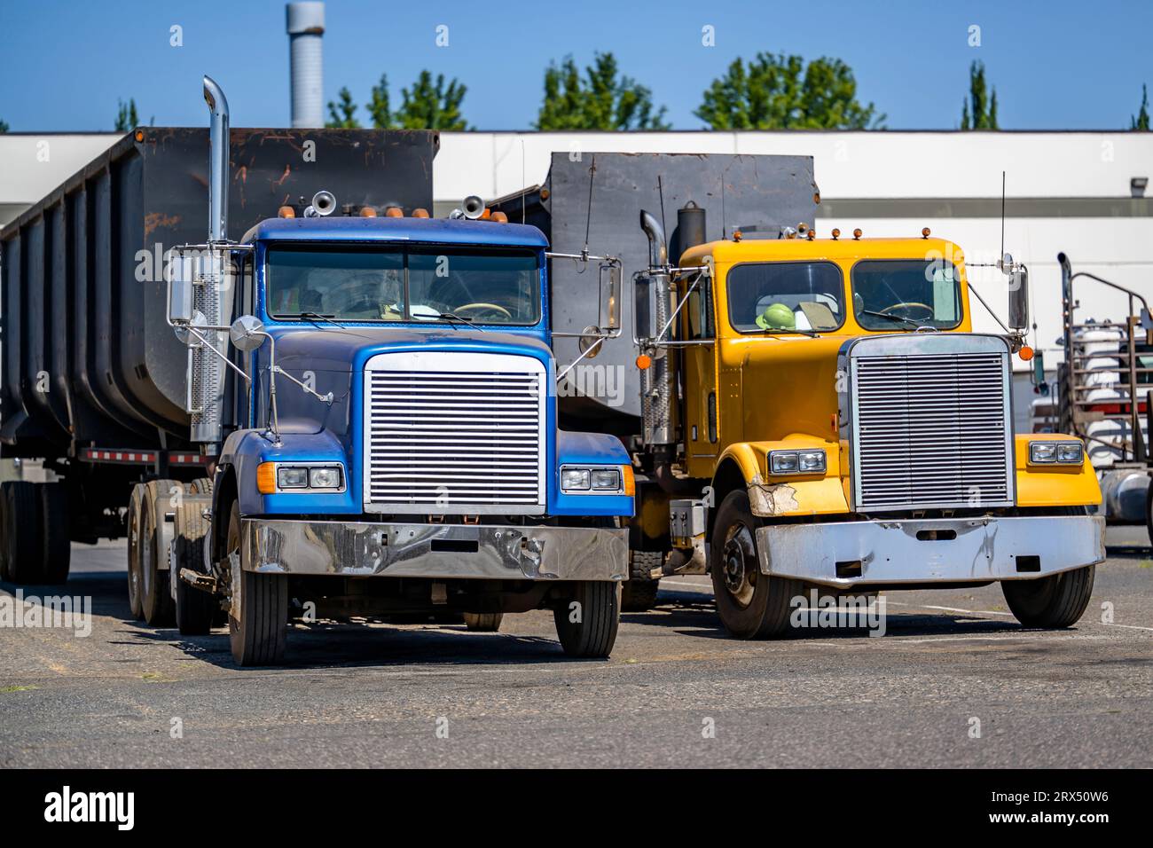 Yellow and blue old style day cab big rig semi trucks tractors with ...