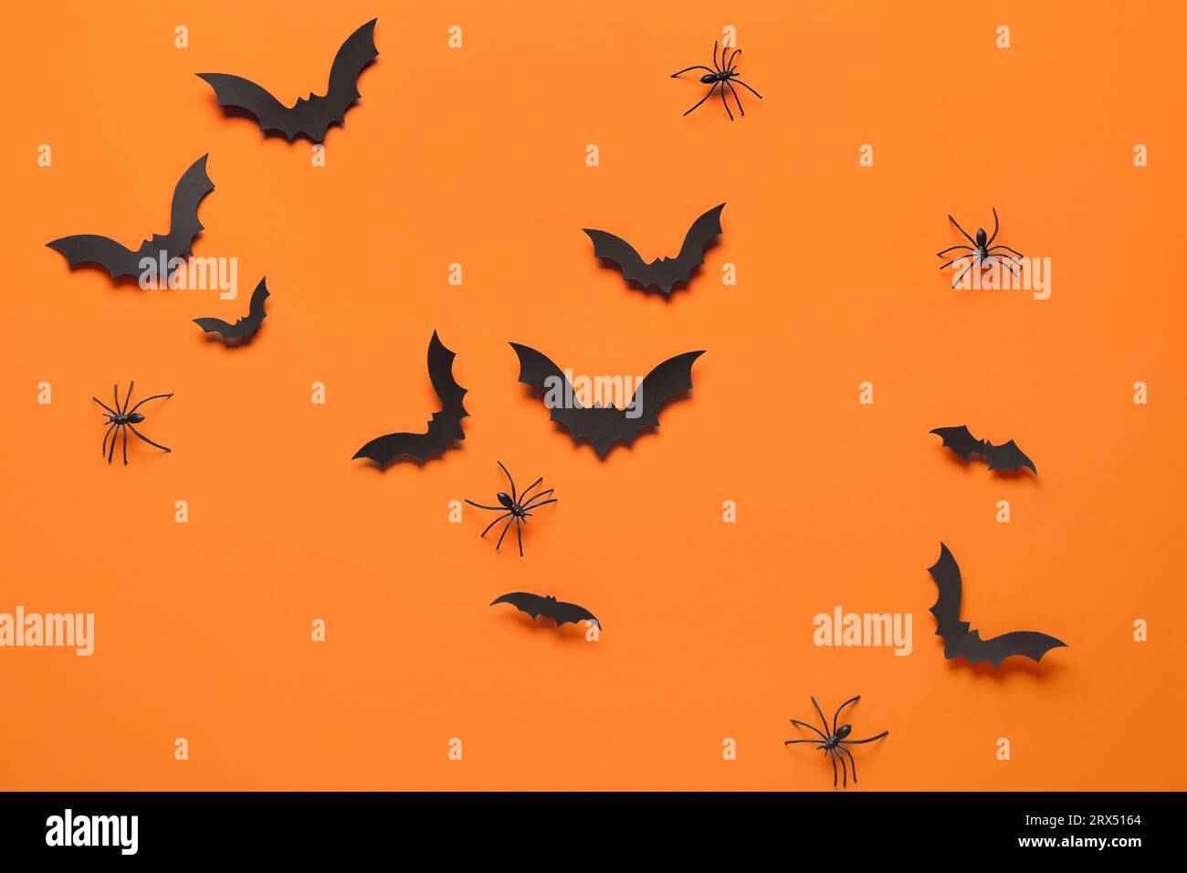Paper bats and spiders for Halloween party on orange background Stock ...