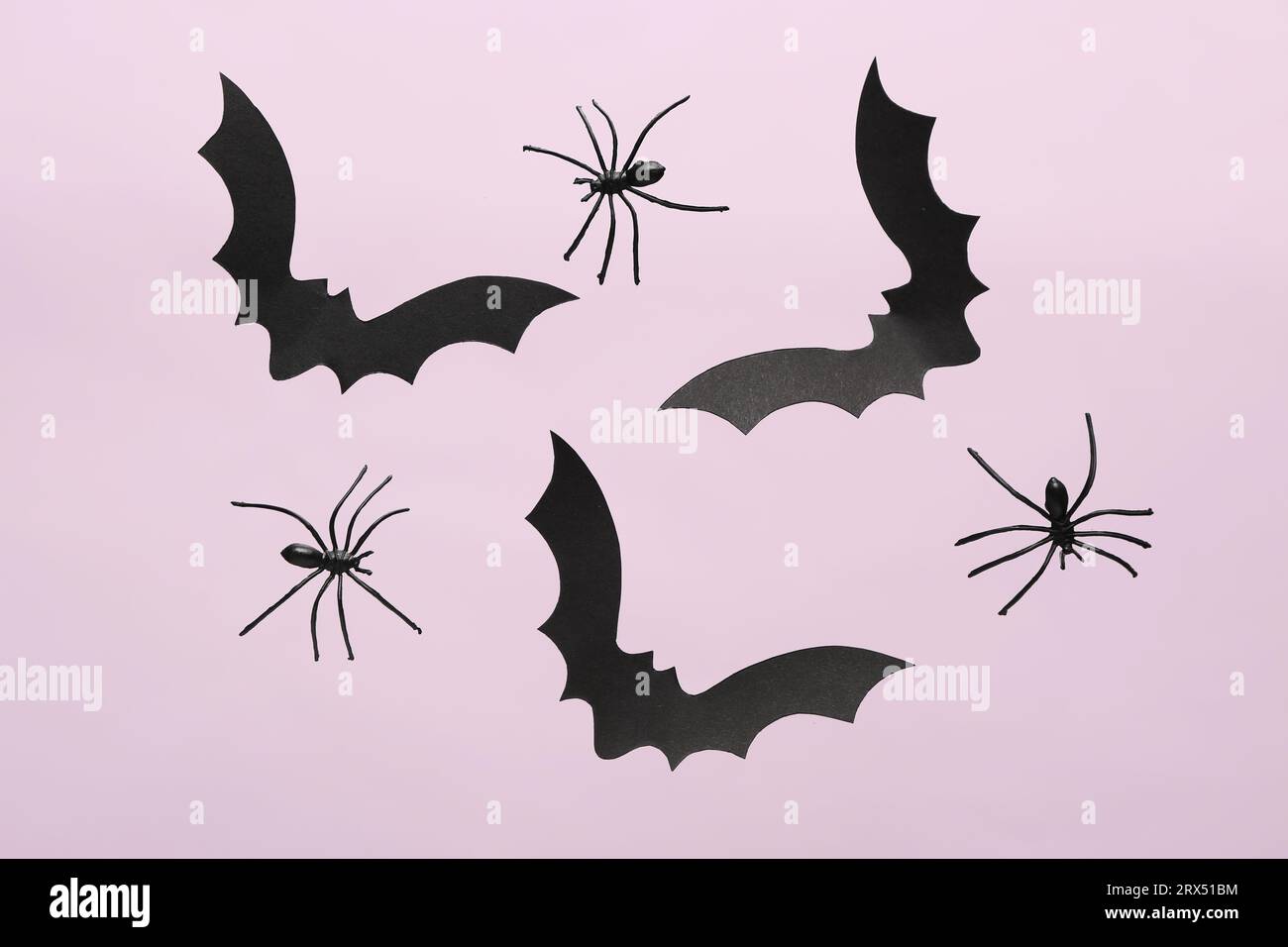 Paper bats and spiders for Halloween party on lilac background Stock ...