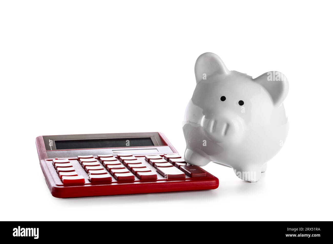 Piggy bank and calculator isolated on white background Stock Photo - Alamy