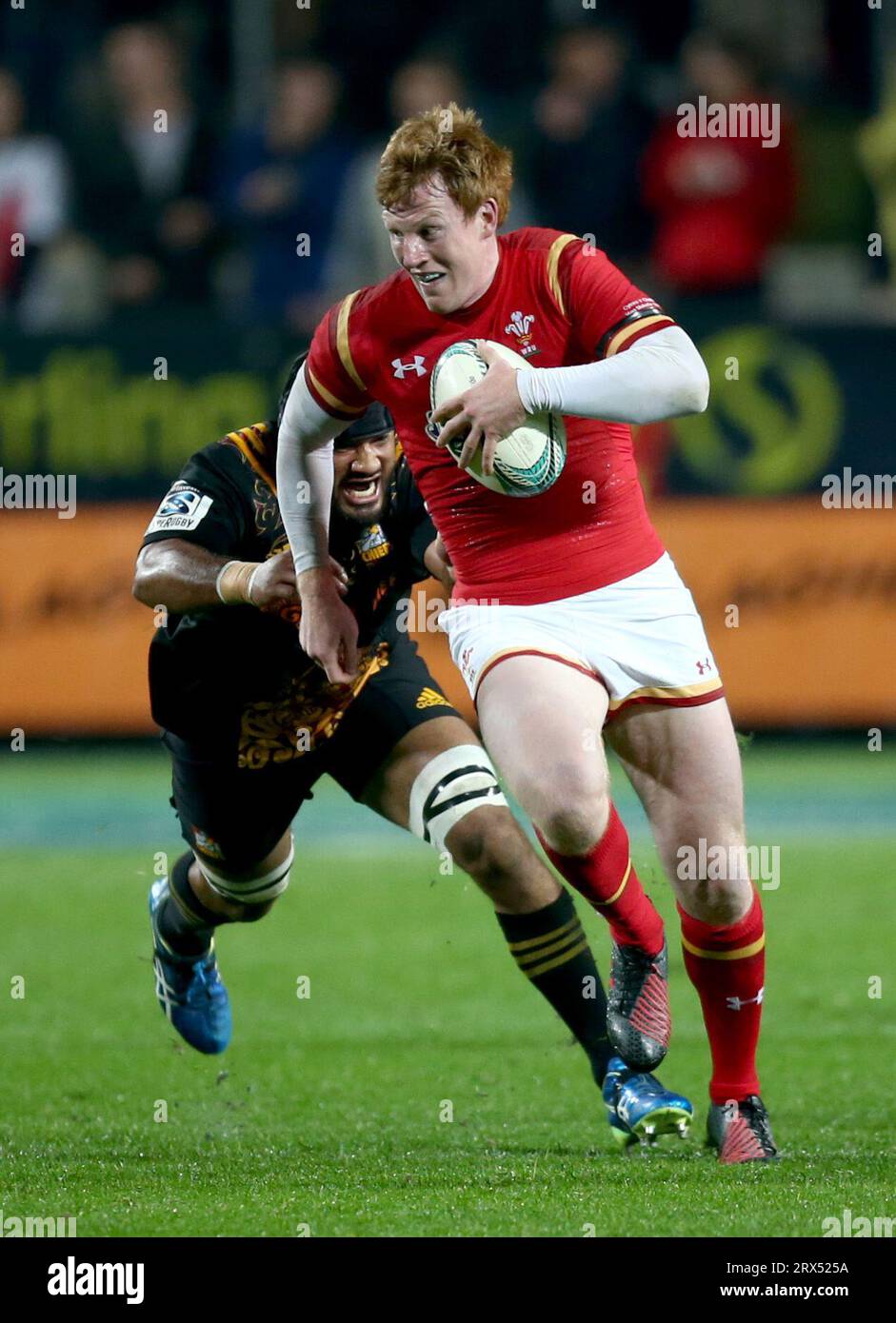 Taleni Seu of the Chiefs chases Rhys Patchell of Wales during the rugby match between the Chiefs and Wales at Waikato Stadium in Hamilton, New Zealand Stock Photo