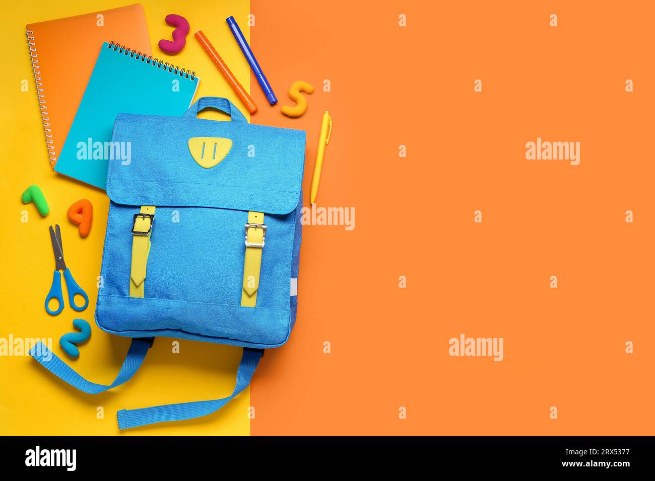 Stylish school backpack with different stationery on color background Stock Photo
