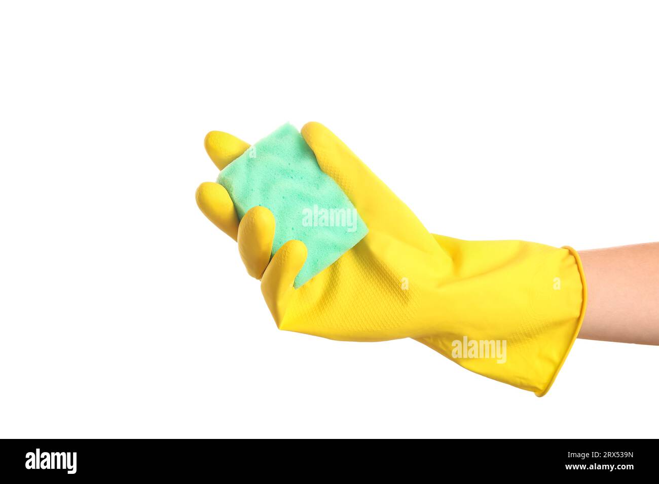 Female hand in yellow rubber glove holding sponge on white background ...