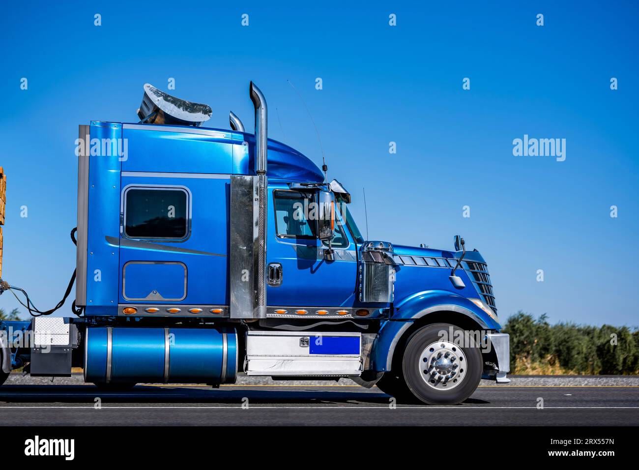 Bright blue industrial long hauler classic carrier big rig semi truck