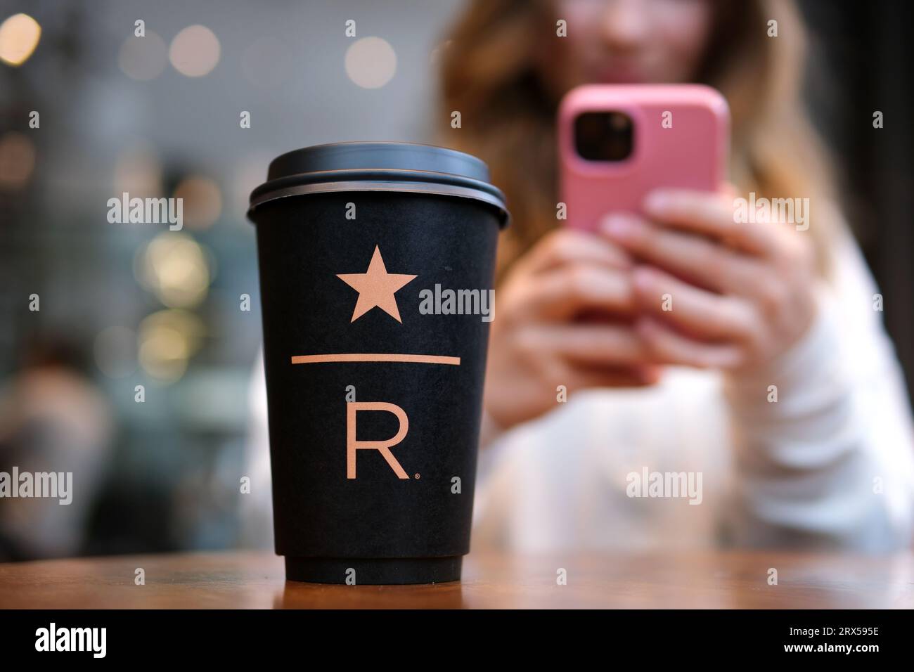 Starbucks Resort black Starbucks cup with star underline big letter R on the table in the coffee shop delicious new coffee luxury. famous brand newest Stock Photo