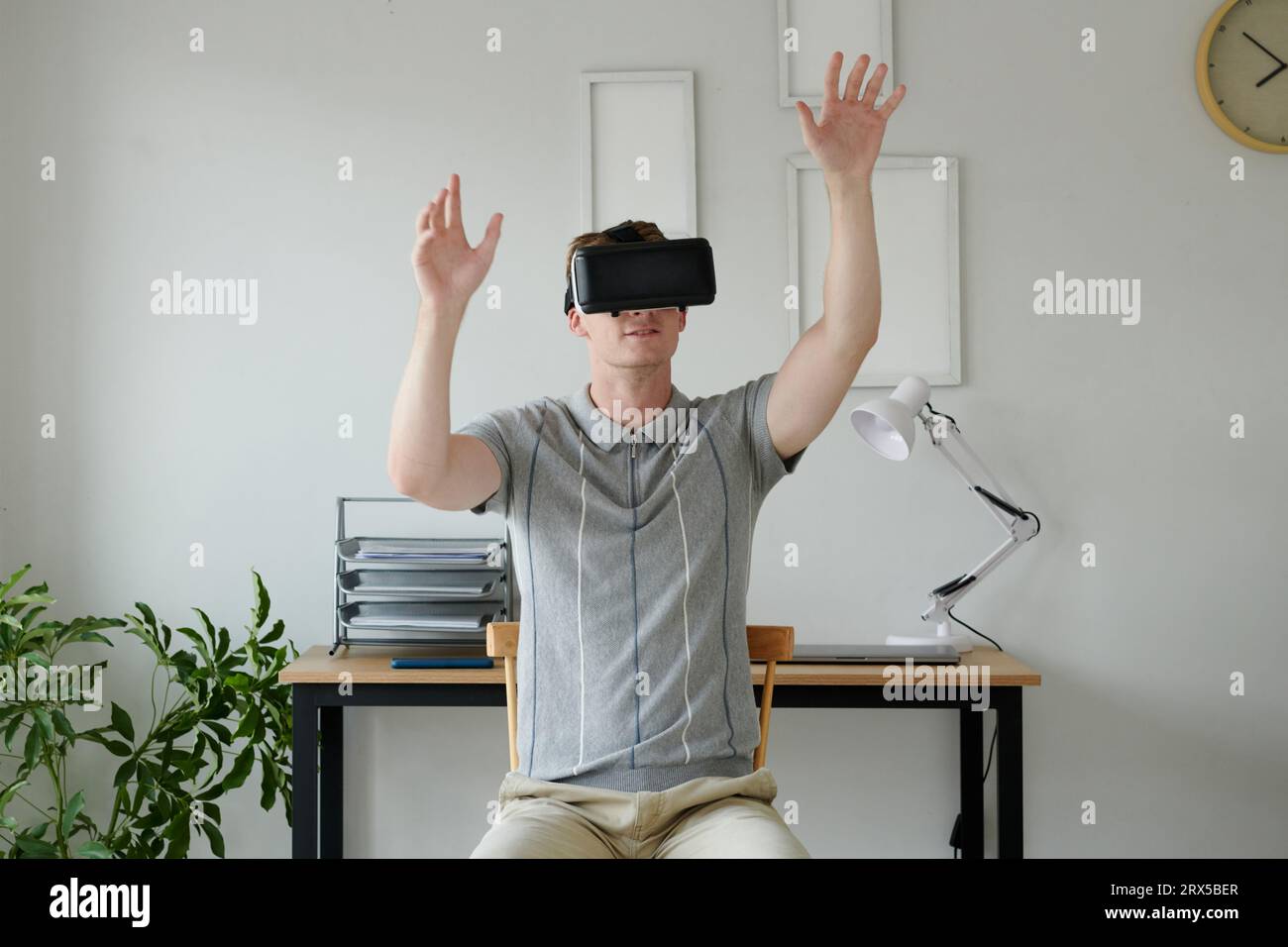 Young man testing his new application for vr headset Stock Photo
