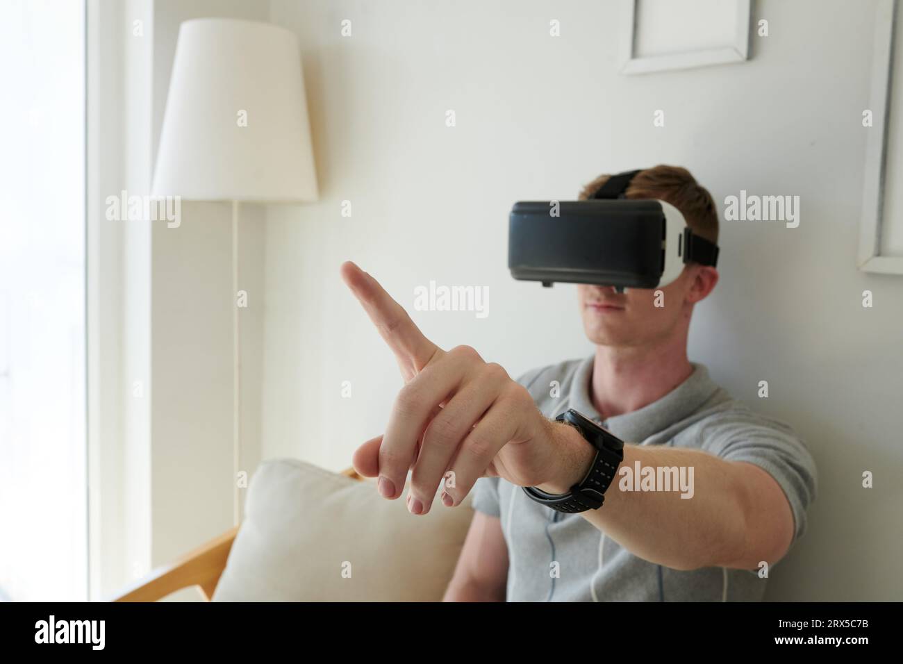 Software developer testing new application for vr headset he created Stock Photo