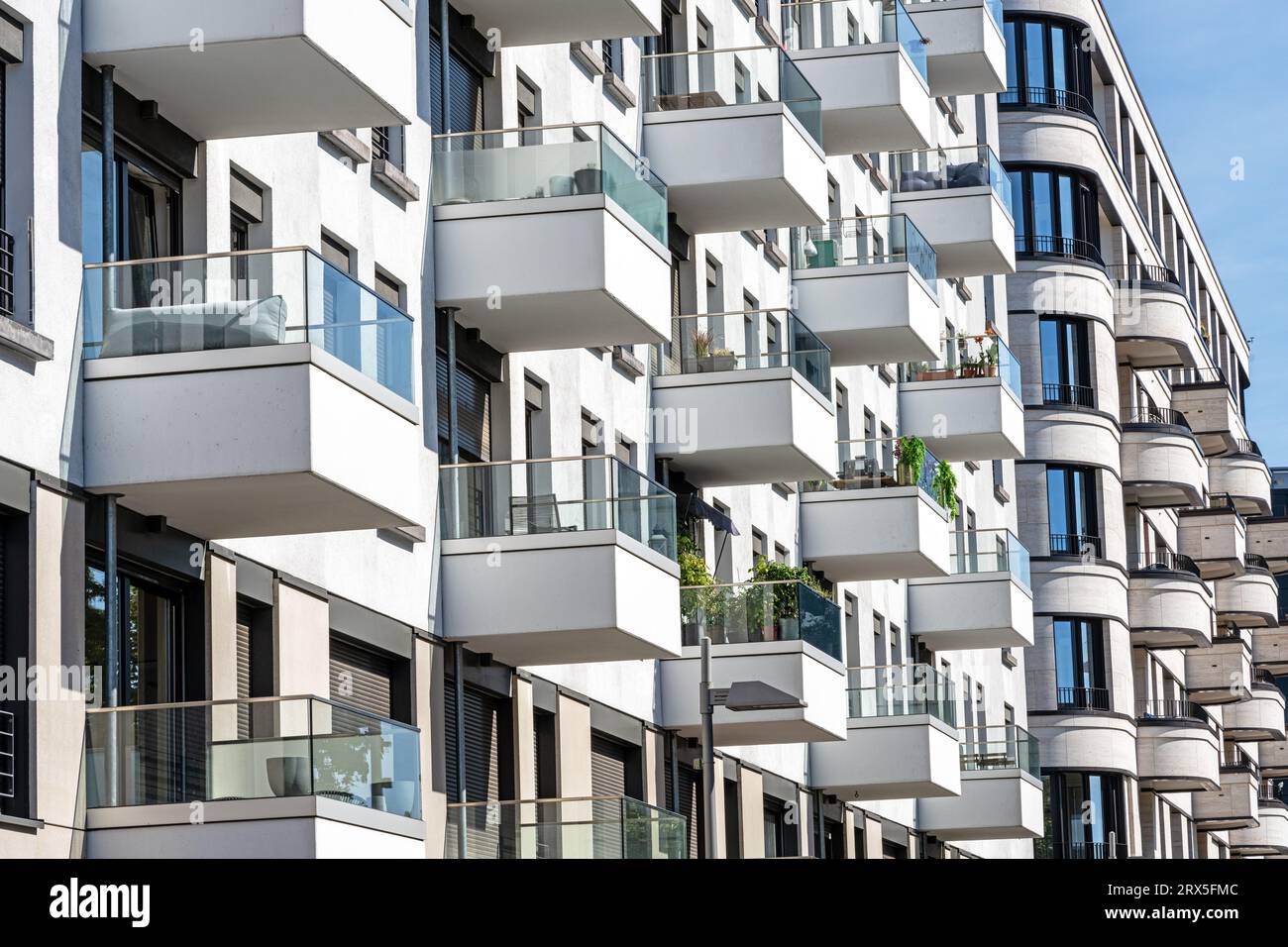 The facade of a white modern apartment building with many small balconies, seen in Berlin, Germany Stock Photo