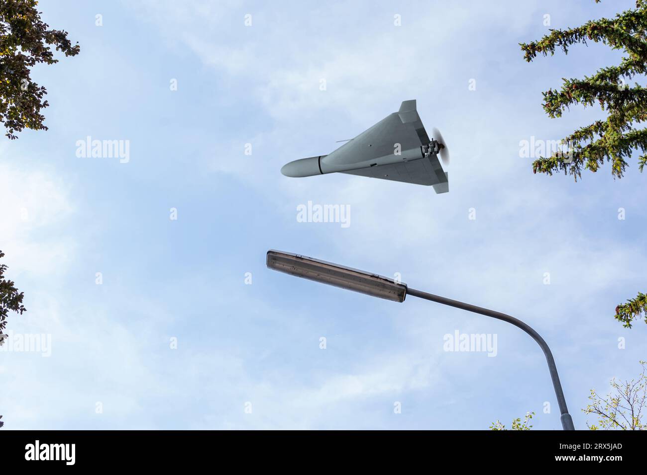 Shahed combat drone flying over city fan and sky , view from below, drone attack on power facilities and infrastructures, war in Ukraine, 3d render. Stock Photo