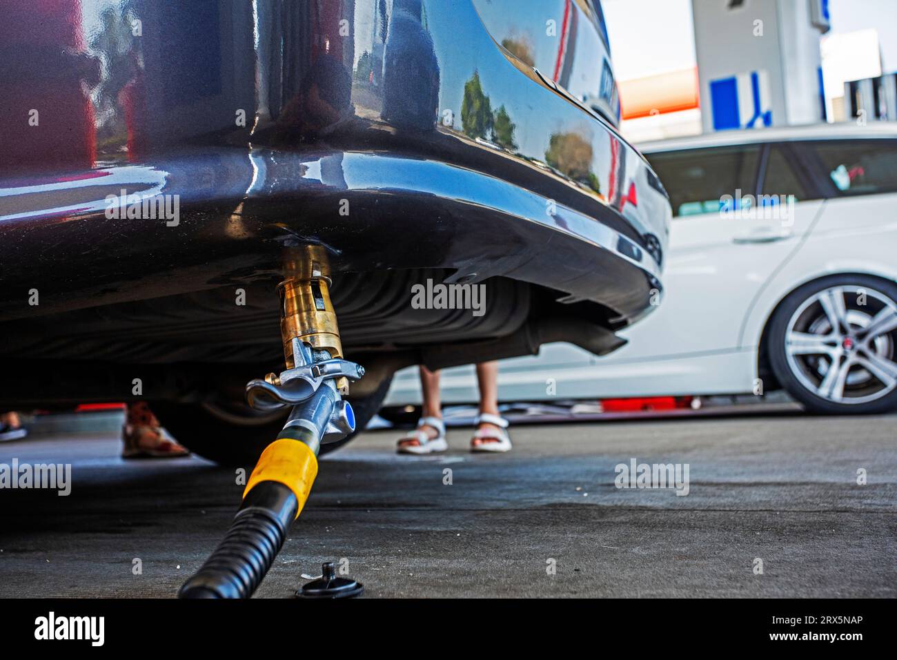 filling a car with an LPG (liquefied petroleum gas) hose from the