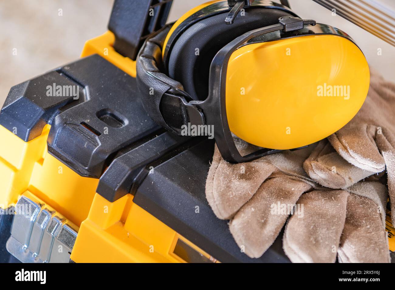 Construction Site Noise Reduction Headphones and a Gloves Close Up. Industrial Theme. Stock Photo