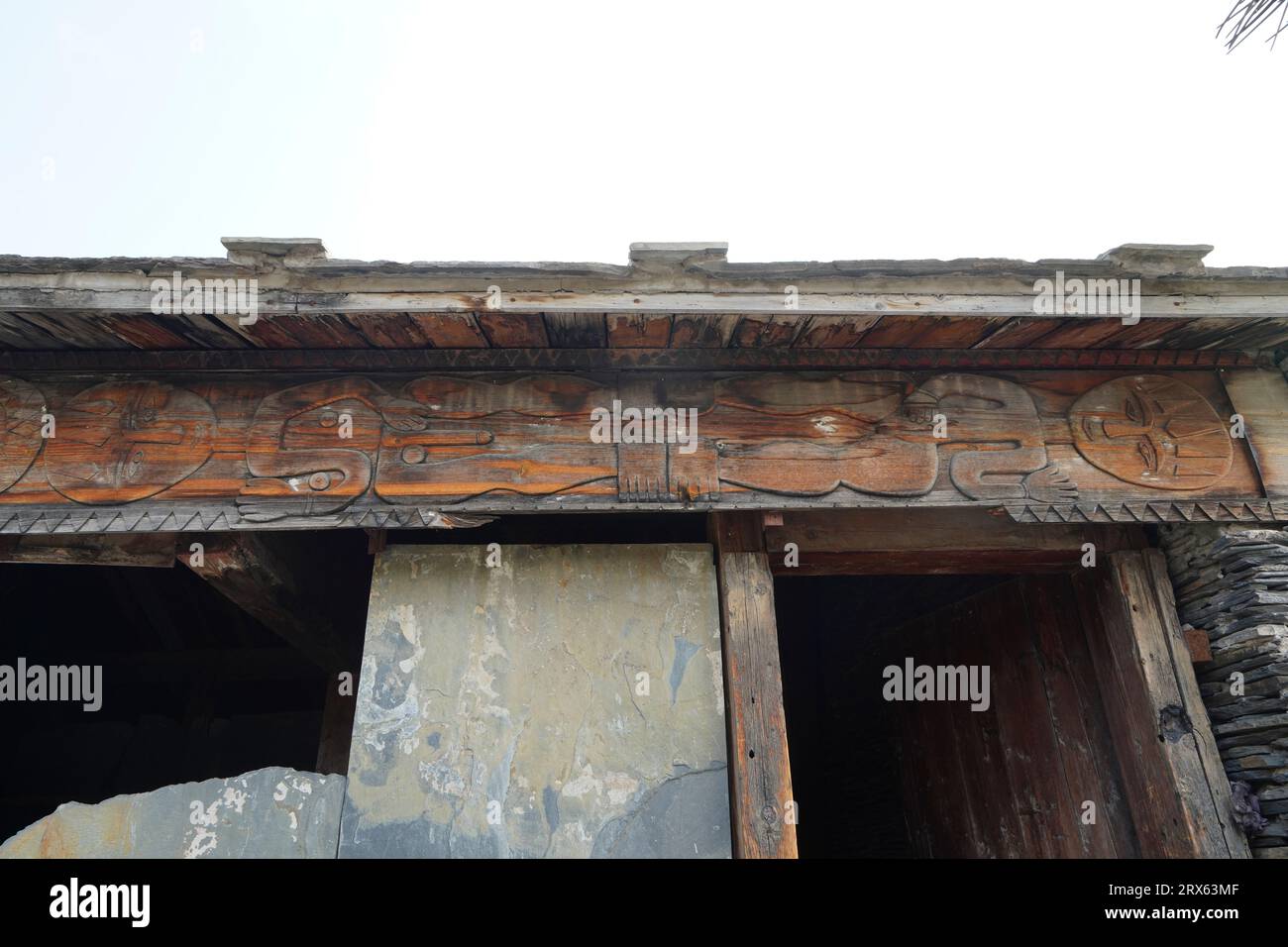 Woodcarving of figures on Paiwan people's slate houses in Taiwan Scenic Area of China Ethnic Museum in Beijing Stock Photo