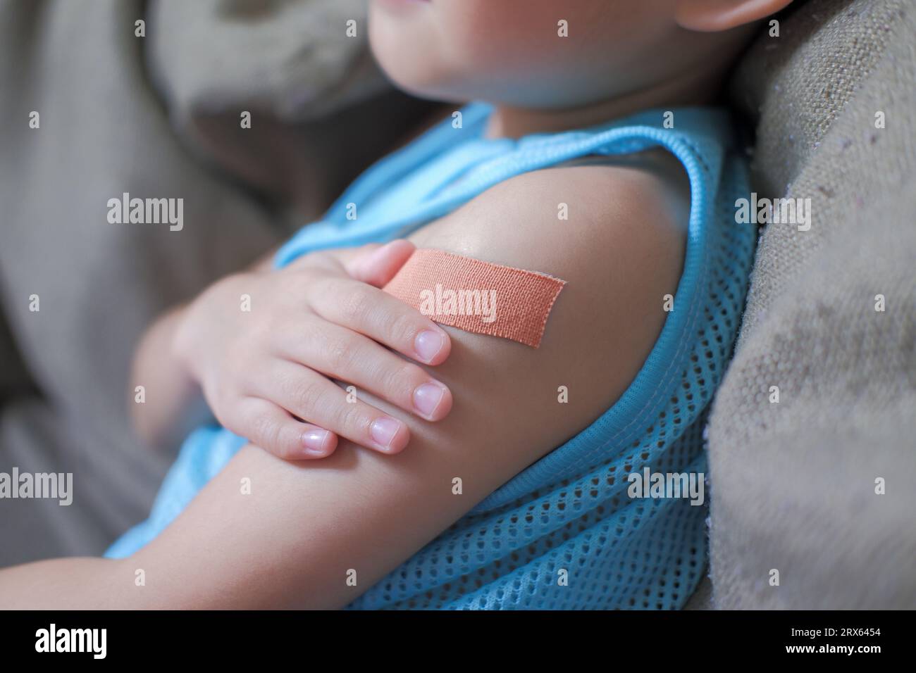 A boy hurts his arm, holding his bandaged arm Stock Photo Alamy