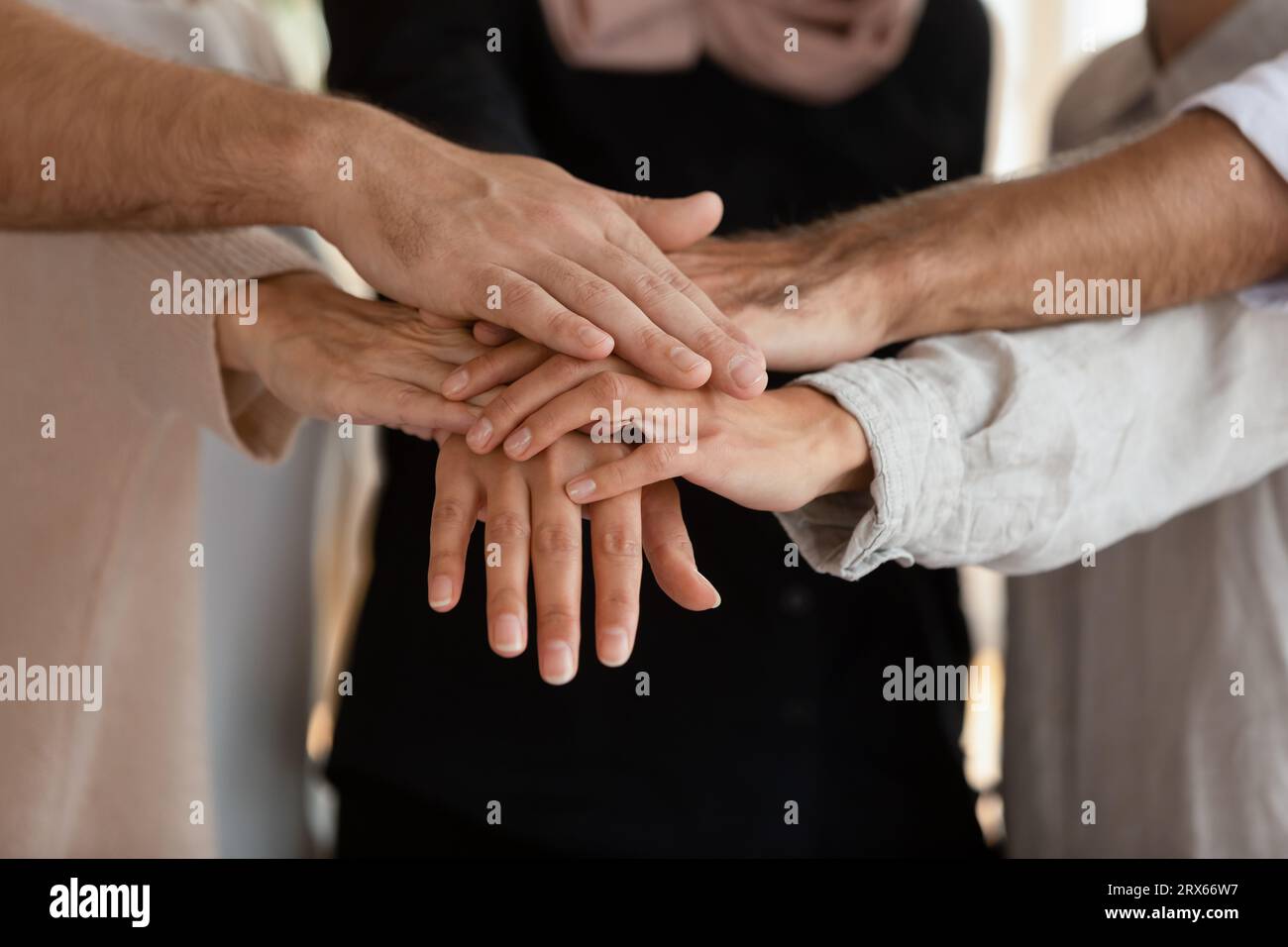 Like-minded people stacked palms together feeling unity close up Stock ...