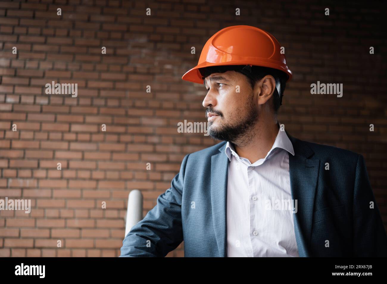Contemplative engineer standing at construction site Stock Photo