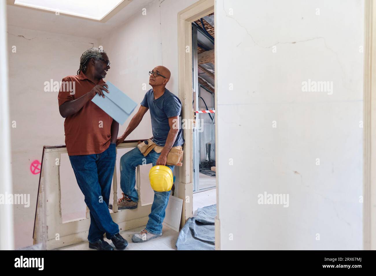 Architect and builder having discussion at site Stock Photo